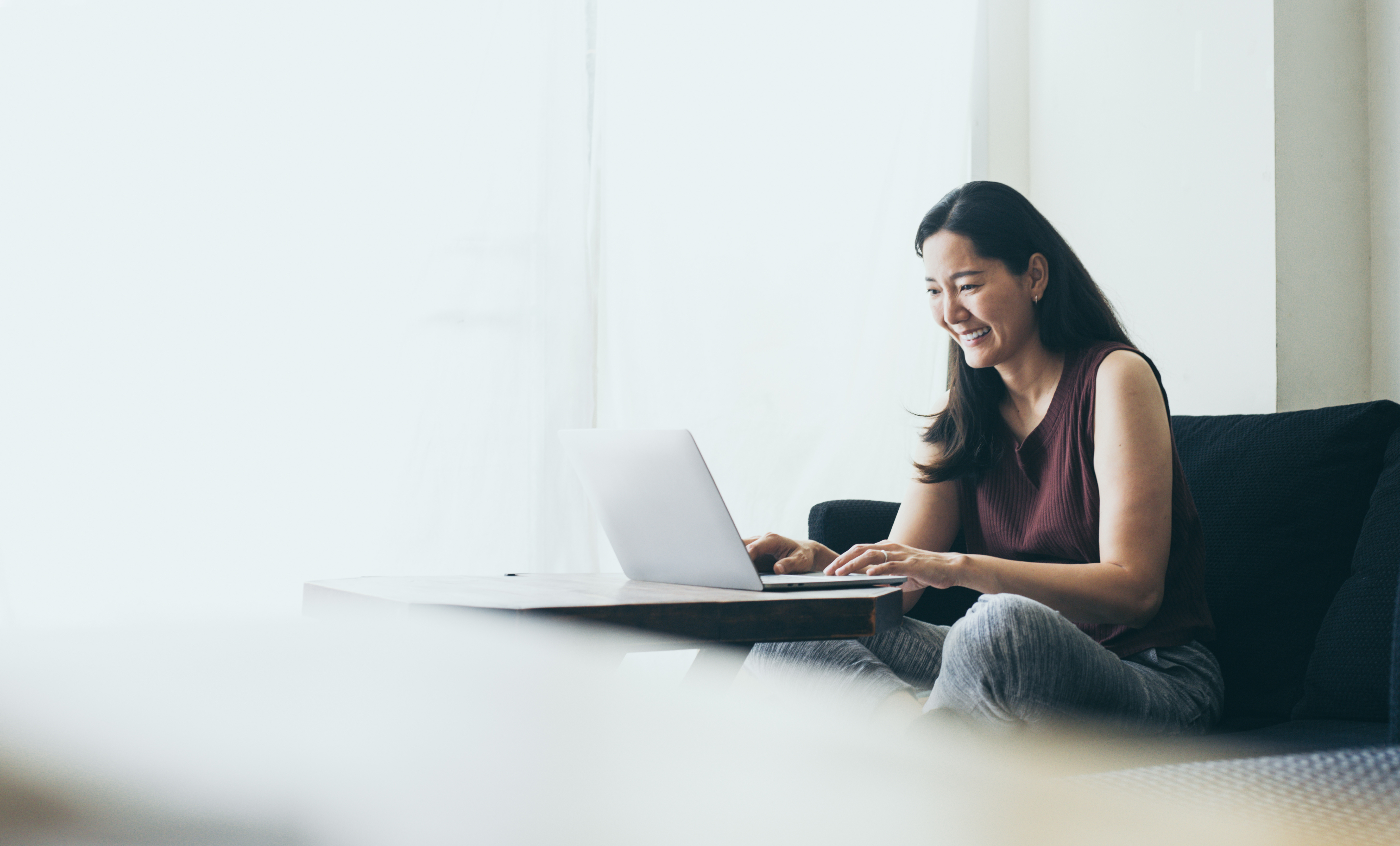 Woman reviewing her finances on a laptop at home
