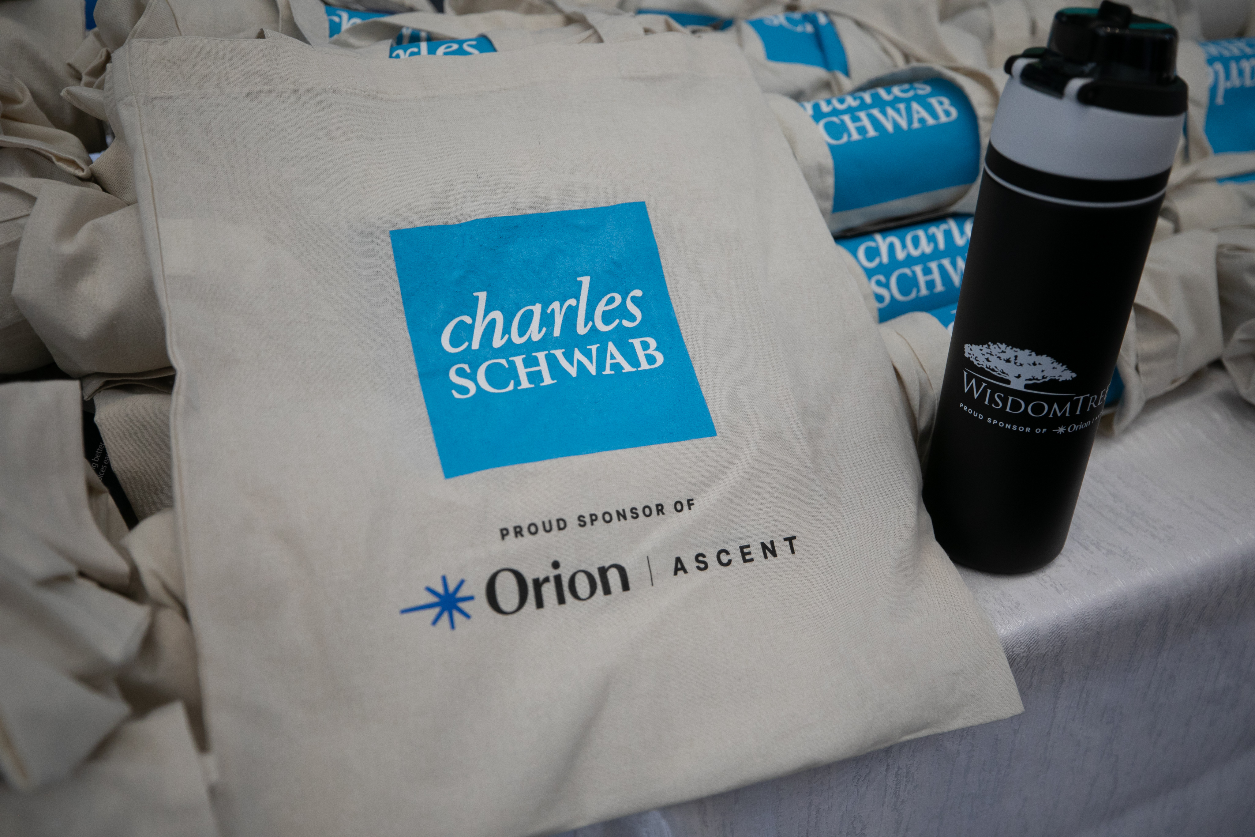 Co-branded Charles Schwab and Orion Ascent sponsor tote bags