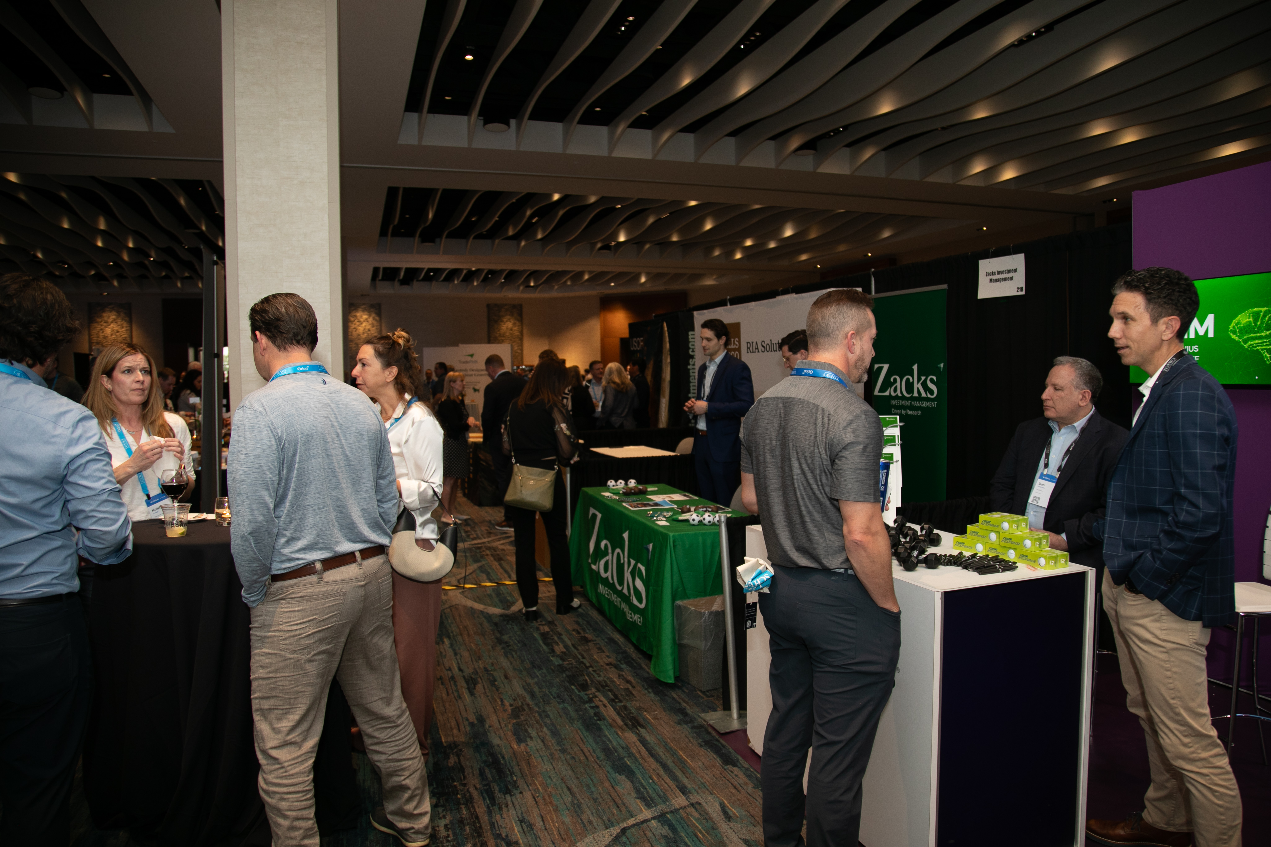 Advisors talking with sponsors at exhibit hall booths