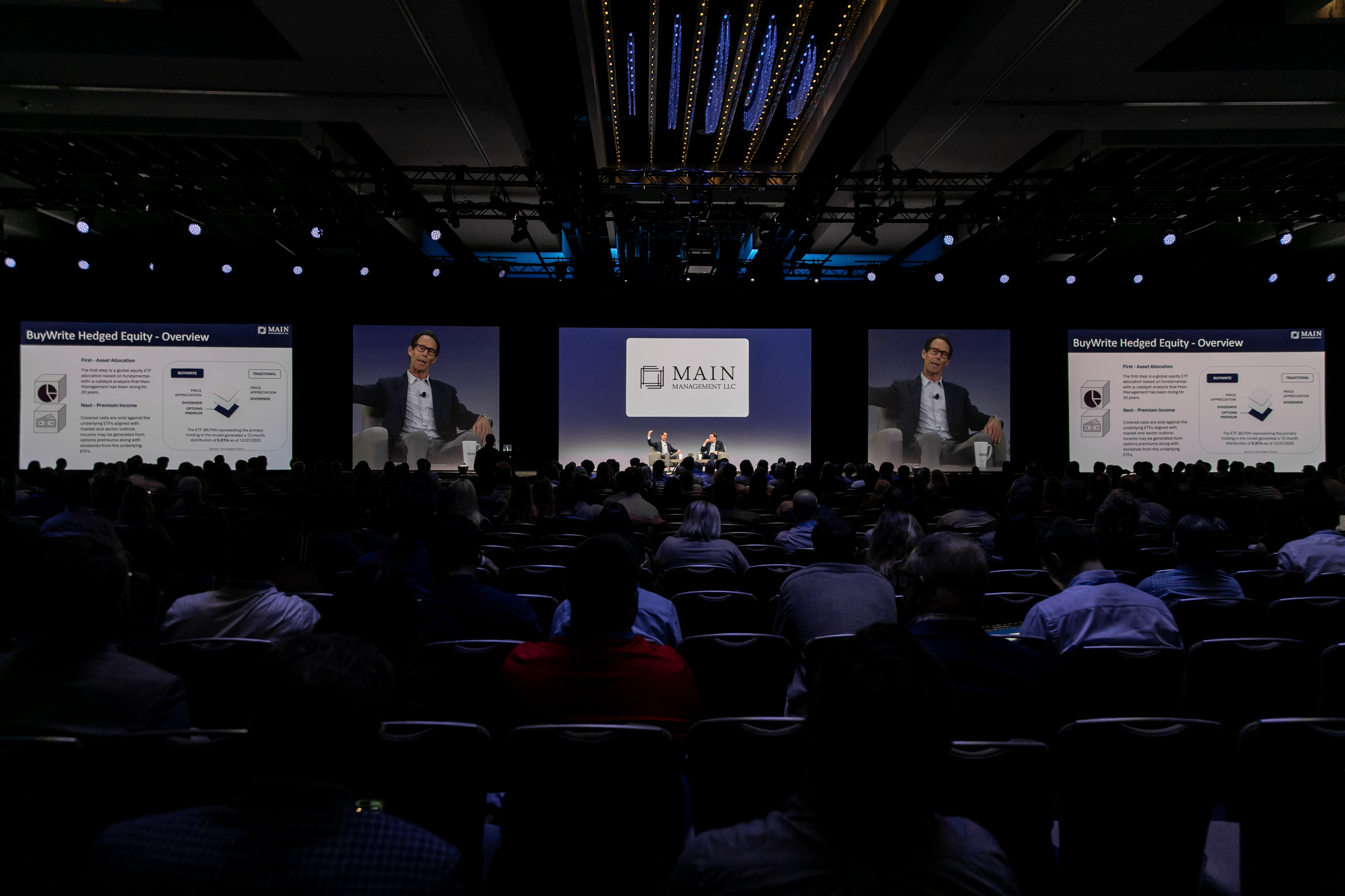 Sponsor logo on screen during a packed main stage general session at Orion Ascent 2026