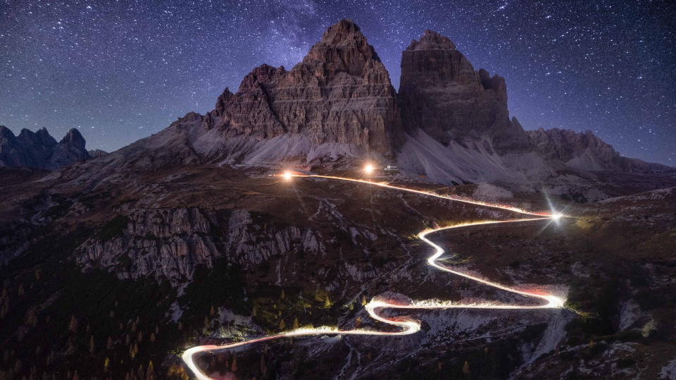 Time-lapse headlights on mountain road at night