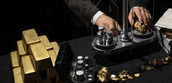 Weighing natural gold nuggets on precision scales at a mint or agency. 