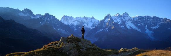 A man looks out at the mountains in France