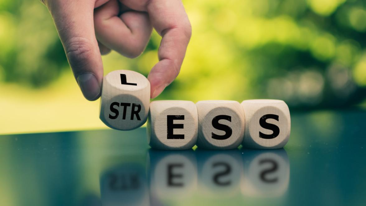 Having less stress or being stress-less. Hand turns a cube and changes the word "STRESS" to "LESS".
