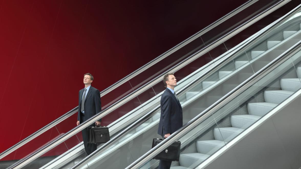 business man going up and down escalators, concept of choice and success