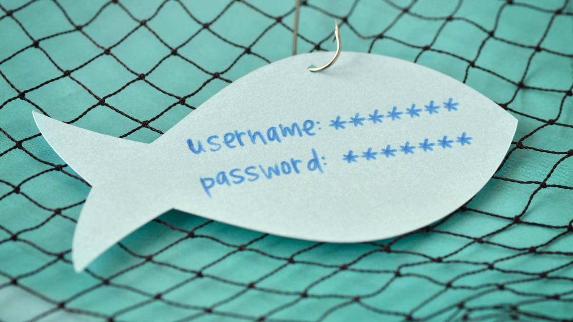 Username and password written on a paper note in the shape of a fish attached to a hook - Phishing and internet security concept