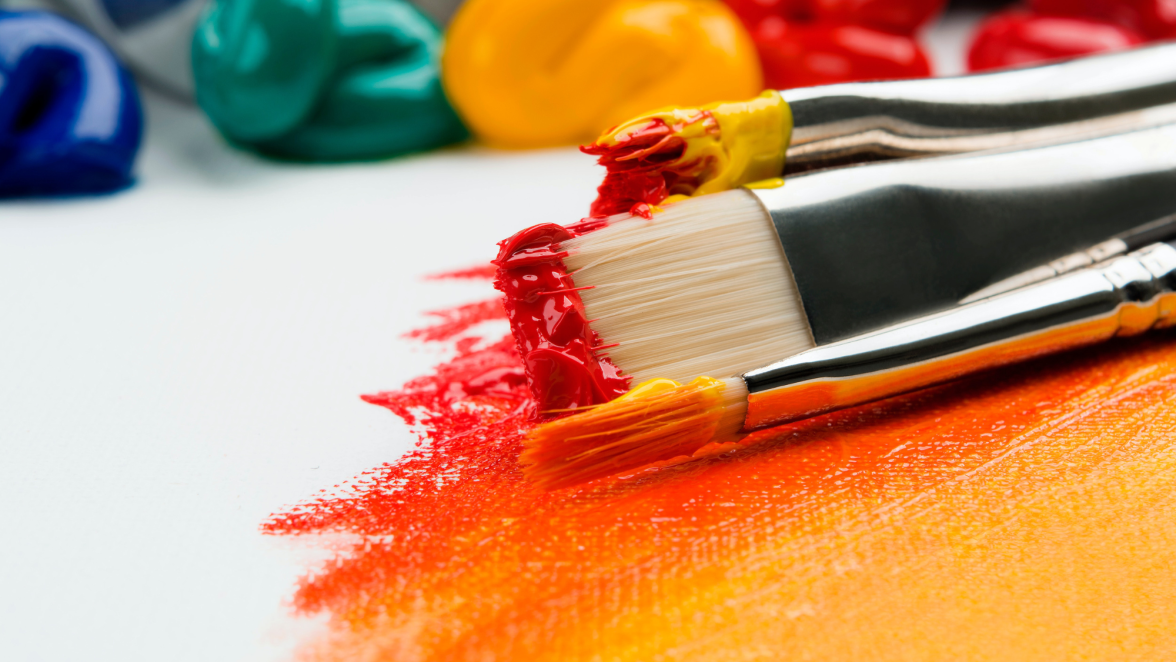 Paintbrushes with paint on a canvas