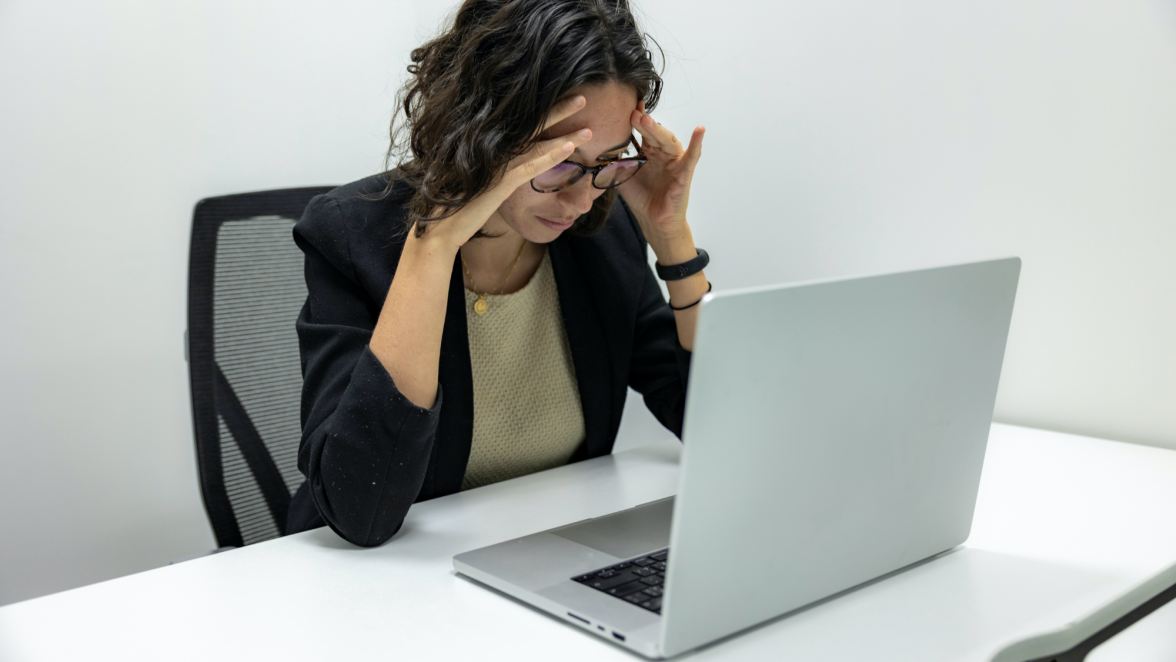 Frustrated woman looking at computer