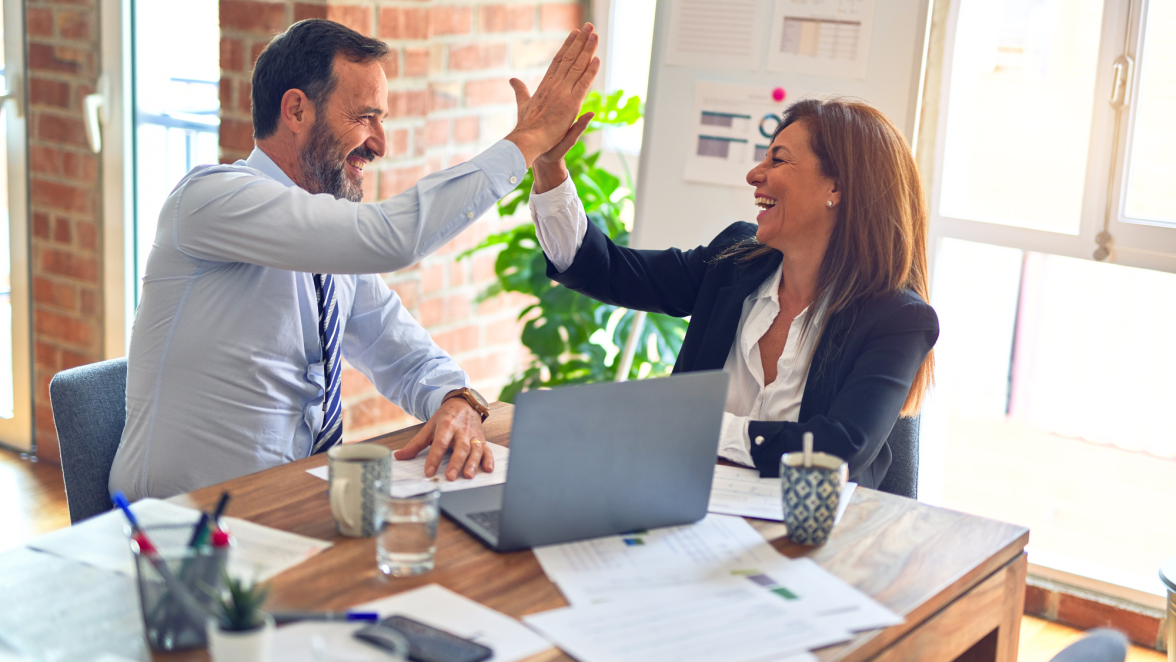 Office workers high-fiving