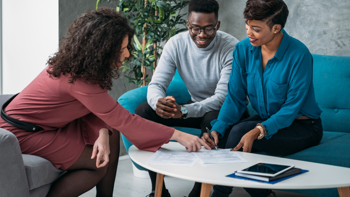 Financial advisor reviewing paperwork with couple