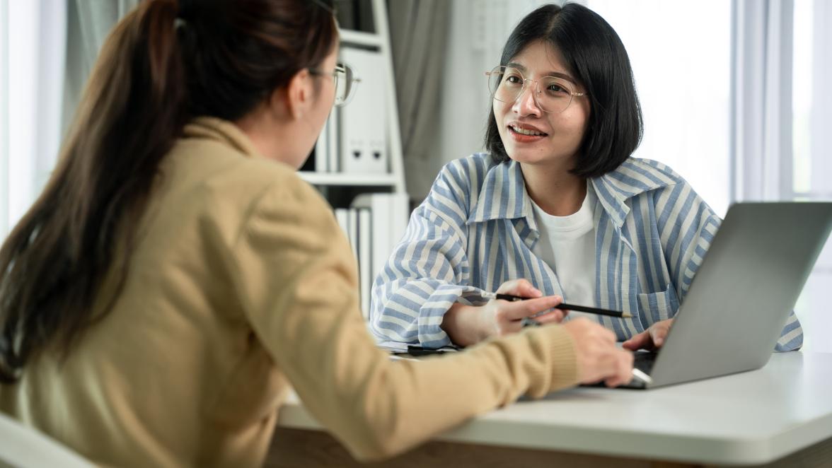 Financial advisor and client looking at computer