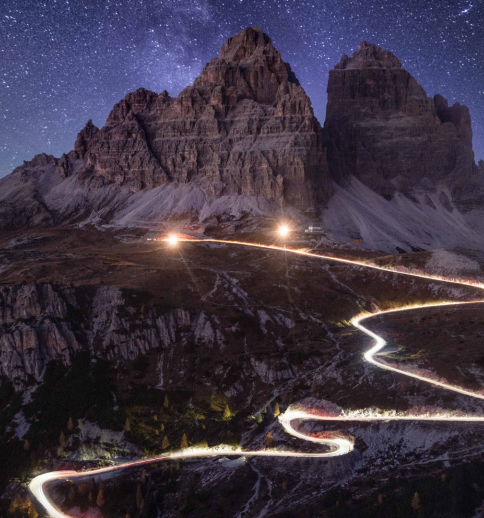Time-lapse headlights on mountain road at night