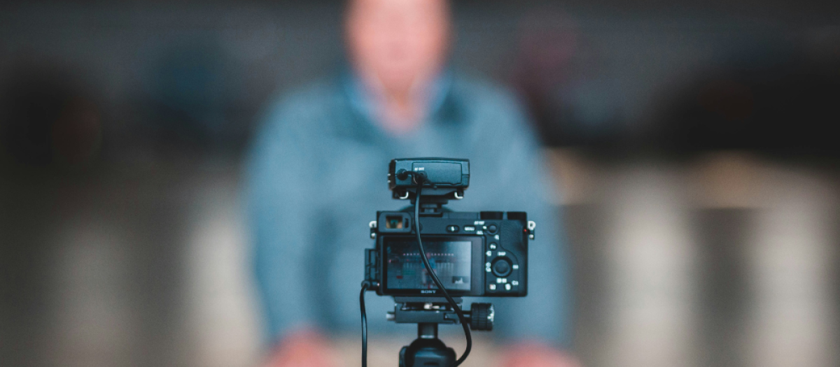 Camera on tripod filming blurred man