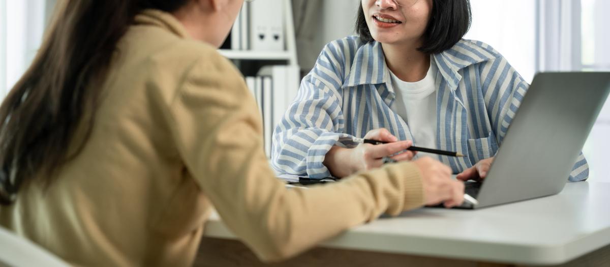 Financial advisor and client looking at computer