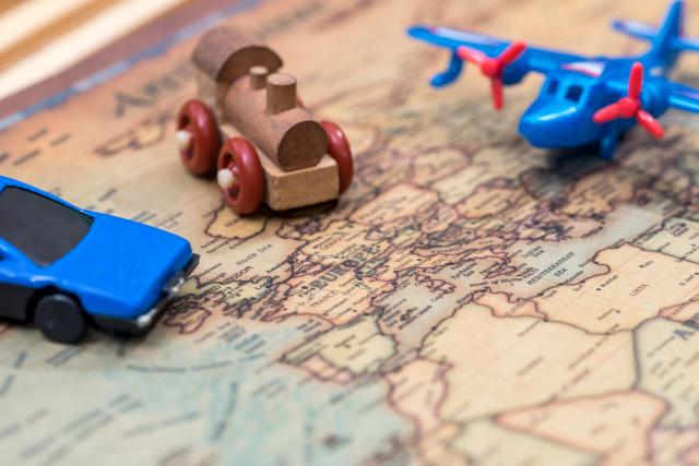 small-toy-car-plane-and-train-on-map