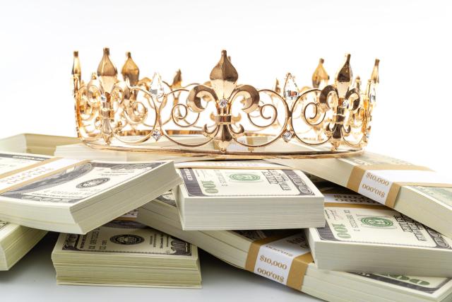 cash-is-king-economic-treasure-and-financial-successful-retirement-conceptual-idea-with-gold-metal-crown-on-pile-of-100-dollar-bills-isolated-on-white-background