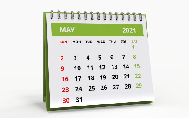 standing-desk-calendar-may-2021-business-monthly-calendar-with-metal-spiral-bound-the-week-starts-on-sunday-monthly-pages-on-a-white-base-and-green-title-isolated-on-a-white-background-3d-render