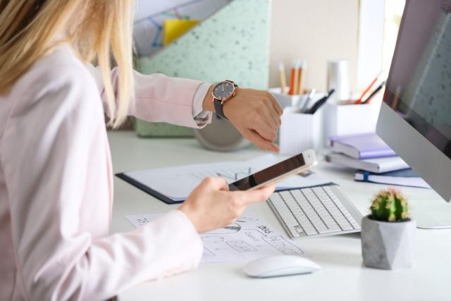 Blank checklist with space for ticks on pad on office desk. Checklist for office worker, manager, businessman, chief on dark wooden background top view.