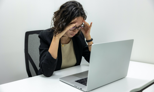 Frustrated woman looking at computer