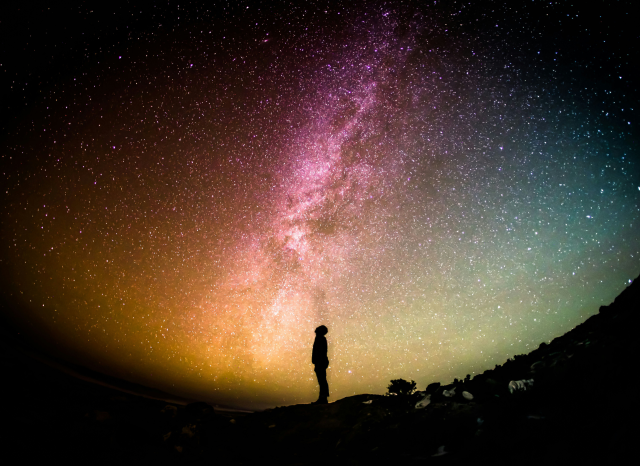 Man looking up at the Milky Way