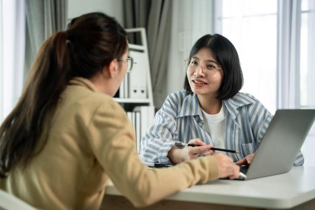 Financial advisor and client looking at computer