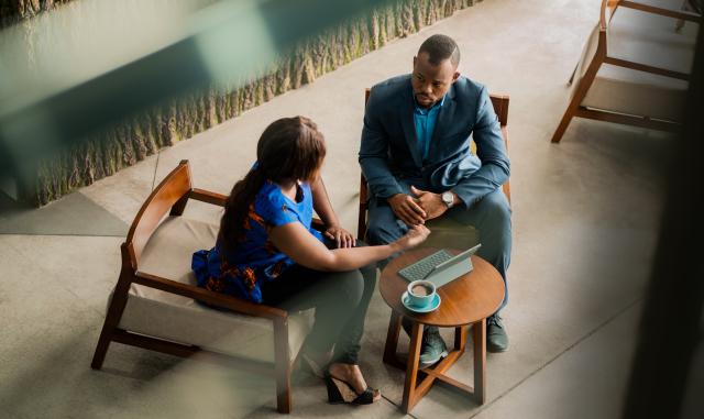 Wide shot of a consultation between a financial advisor and their client.
