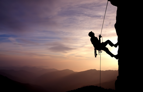 Silhouette of Rock Climber at Sunset