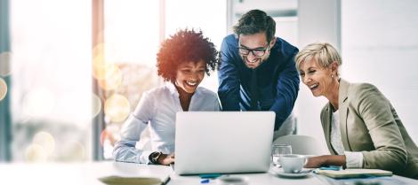 Group of happy employees working on computer