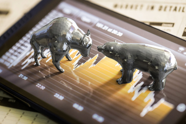 Bull and bear economy concept with 3d rendering bull and bear on stock market chart background