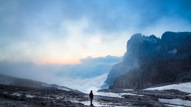 Hiker Looking Out Over Clouds