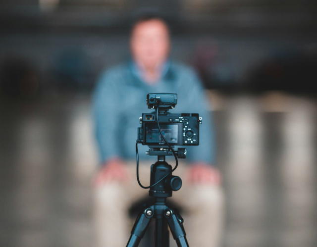 Camera on tripod filming blurred man