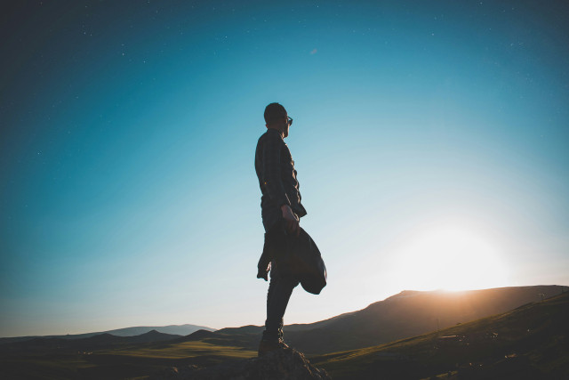 Man watching mountain sunrise