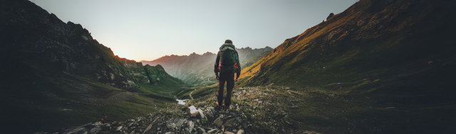 Backpacker hiking in a mountain landscape.
