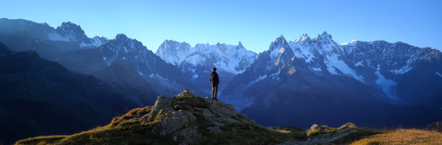 A man looks out at the mountains in France