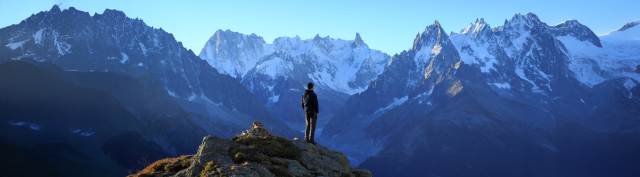 A man looks out at the mountains in France