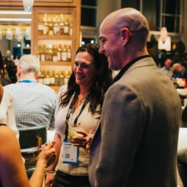 Small group of four people chat at a bar