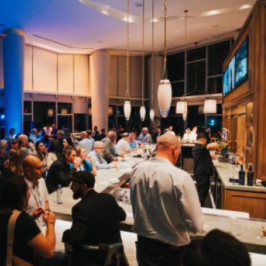 A crowd packs in at a dimly lit upscale bar