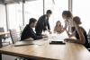 Team discussing work around conference table